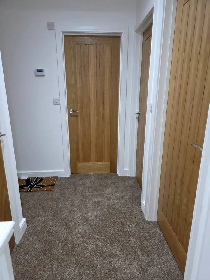 Freshly cleaned hallway and doors after a JTTW residential clean